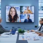 Video Conference Call in Office Boardroom Meeting Room: Executive Directors Talk with Group of Multi-Ethnic Entrepreneurs, Managers, Investors. Businesspeople Discuss e-Commerce Investment Strategy