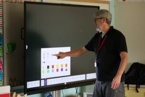 Faculty member at Jamestown, NY school district using an LG CreateBoard in classroom teaching 6