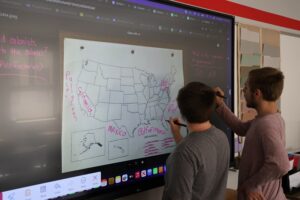 Faculty member at Jamestown, NY school district using an LG CreateBoard in classroom teaching 8