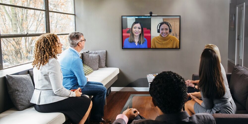 People in a conference room using HP & Poly devices certified for Microsoft Teams.