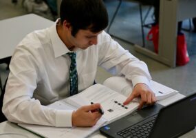 student studying or reading with laptop in front of him, ConnectWise and COMPTIA Ticket to Tech career training initiative