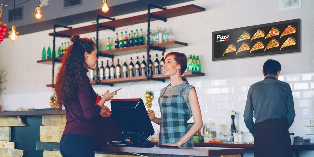 Mockup of PPDS Tableaux range in a restaurant. The display showcases pizzas available for order.