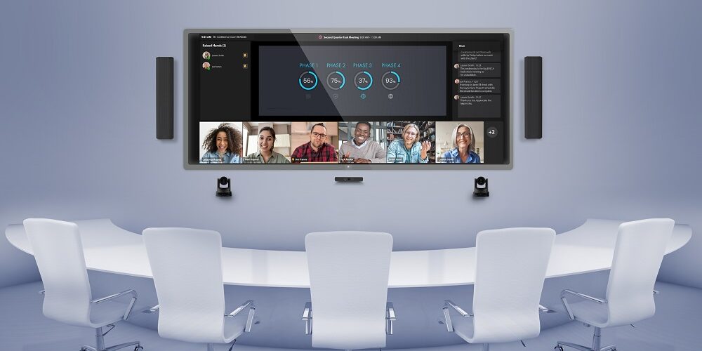 Q-SYS system with Microsoft Teams Rooms displayed on a screen in a conference room.