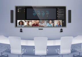 Q-SYS system with Microsoft Teams Rooms displayed on a screen in a conference room.