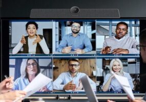 Employees using MAXHUB devices for collaboration with remote employees on the screen.