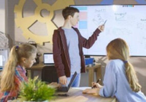 Boy Shows His Presentation on Interactive Whiteboard Project, IT device management, touchscreen